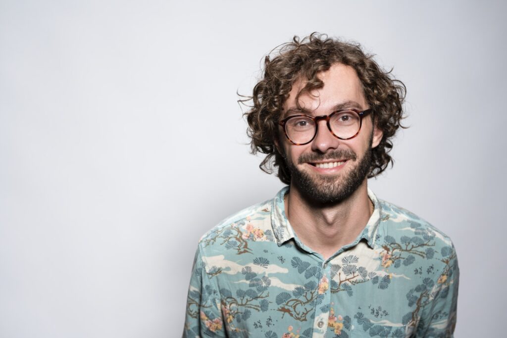 smiling man with glasses and beard portrait